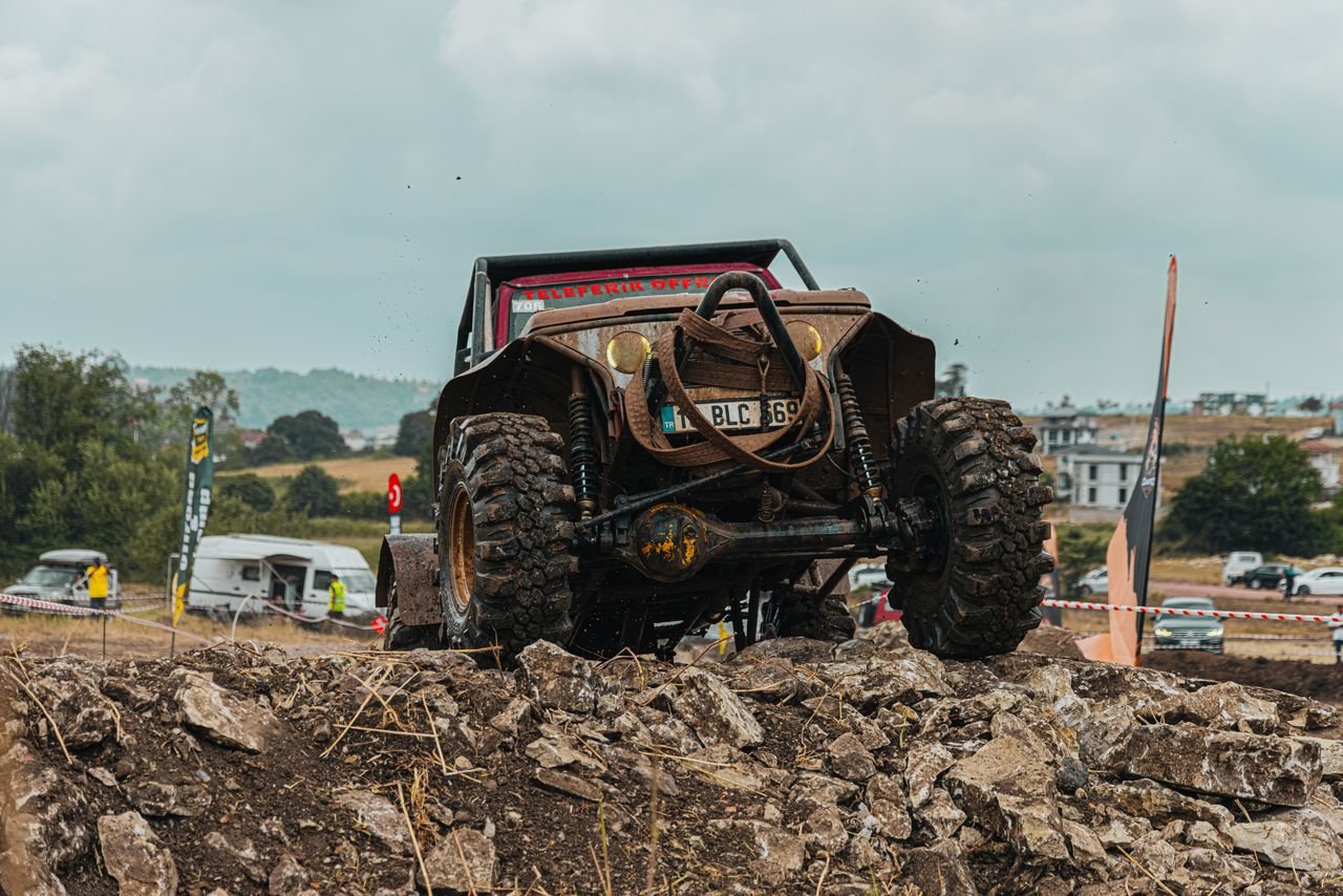 A thrilling off-road race showcasing a rugged 4x4 vehicle conquering rocky terrain.